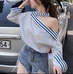 Mia - Elegante camiseta a rayas con hombros descubiertos